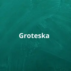 Biały napis "Groteska" na zielonej tablicy. Co to groteska? To styl, który łączy elementy śmieszne i straszne, tworząc niepokojący efekt.