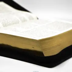 Otwarta księga z pożółkłymi kartkami, w czarnym etui. Dla pielgrzyma to drogowskaz i pocieszenie.