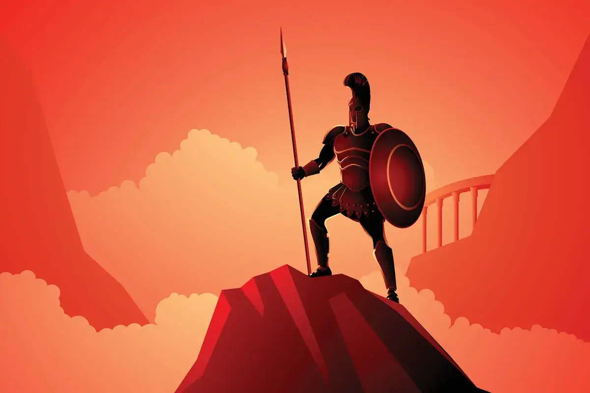Spartanin z tarczą i włócznią na szczycie góry, symbolizujący heroizm i odwagę w walce.